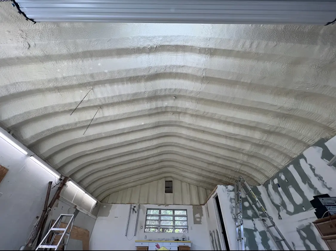 Spray polyurethane foam applied to the underside of a metal roof deck in Booneville
